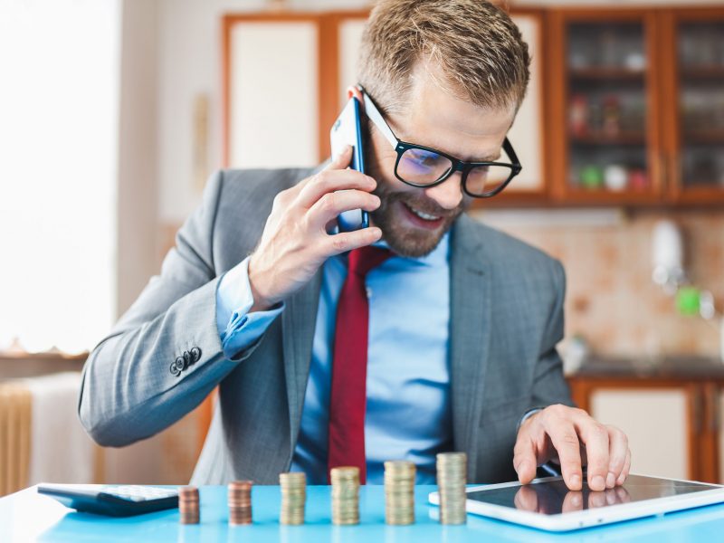 Working from home. Young businessman checking on returns from his investment